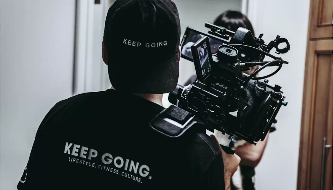 man in black crew neck t-shirt holding black dslr camera