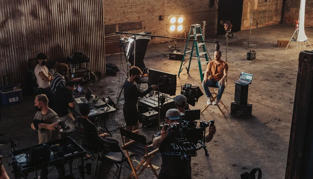 a group of people standing around a camera set up